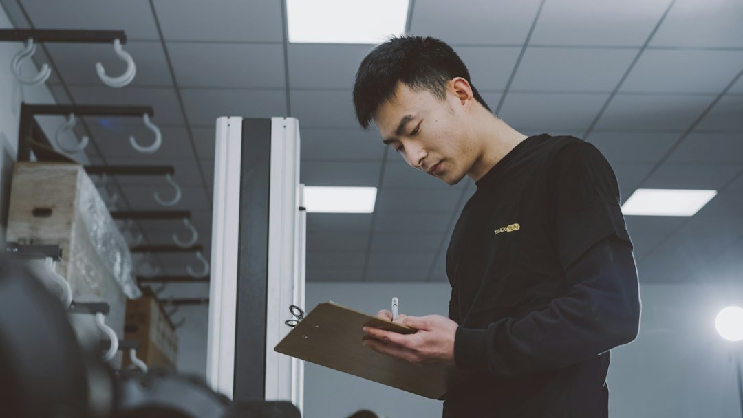 Contractor holding a clipboard while reviewing an interior room